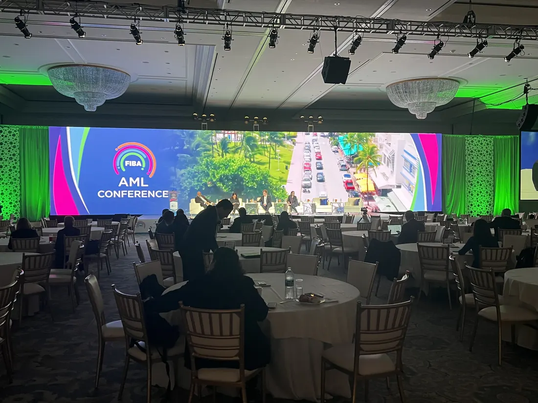 Conference with a wide LED wall and green lighting