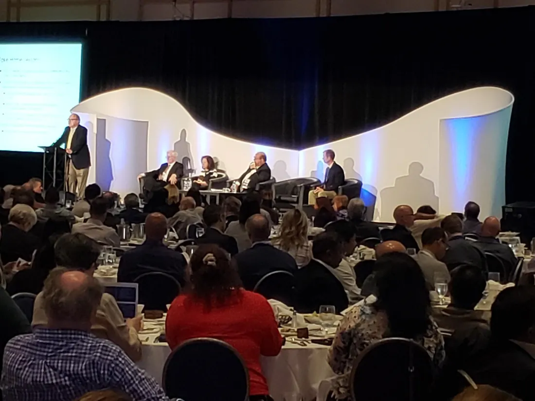 Panel session on a curved white stage